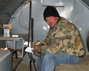 Picture of hunter eating breakfast in one of several underground pits.