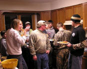Picture kids eating supper after a day of hunting.