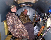 Picture of two hunters in one of several underground pits.